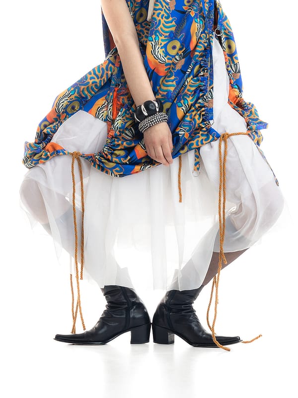 KOE graduate look: patterned dress over white layers with black boots
